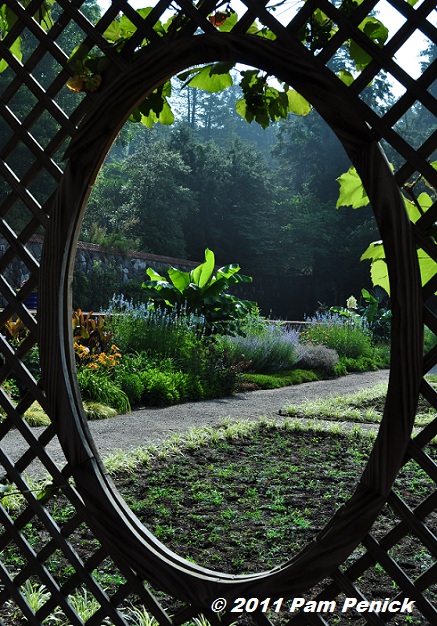 Oval windows are spaced evenly along both sides nicely framing garden views