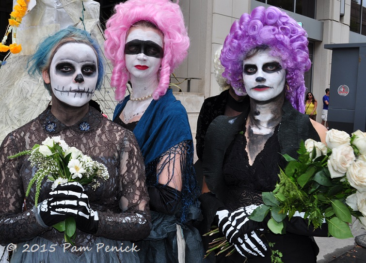 Flower-adorned skeletons at Dia de los Muertos parade