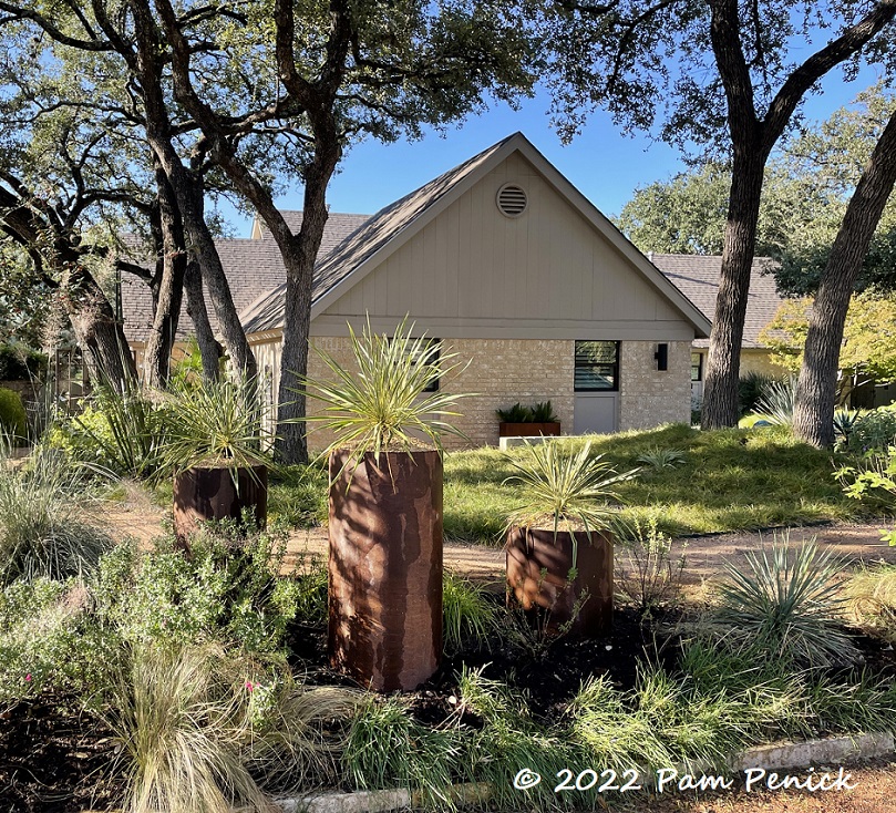 New pipe planters create a focal point in front garden