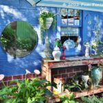 A garden on wheels and colorful decor convert driveway into patio garden