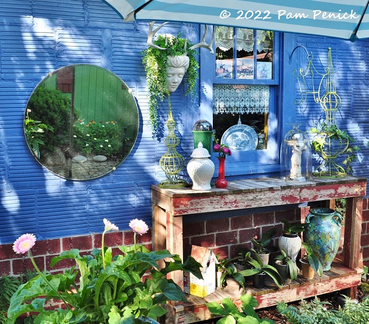 A garden on wheels and colorful decor convert driveway into patio garden