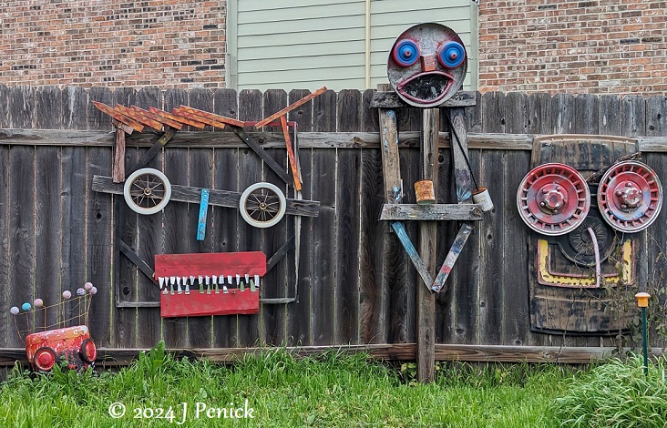 Folk art fence faces in South Austin